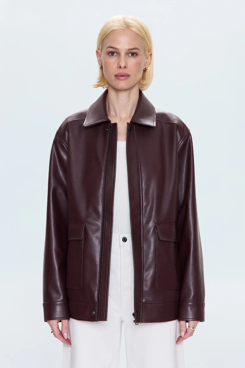 Woman wearing a brown leather jacket on a white background